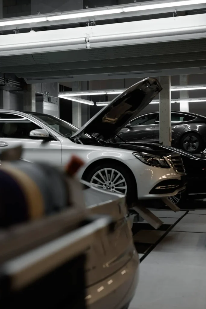 Fahrzeug auf Hebebühne während Inspektion und Wartung in einer modernen KFZ-Werkstatt